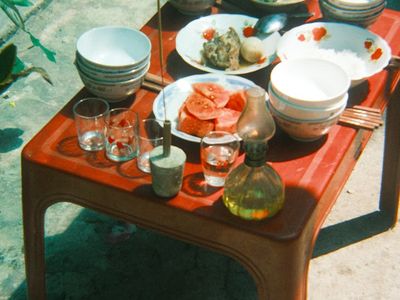 Incense sticks and a bowl of water on a table