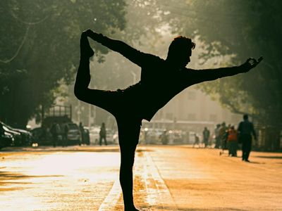 Silhouette of a person in a yoga balancing pose